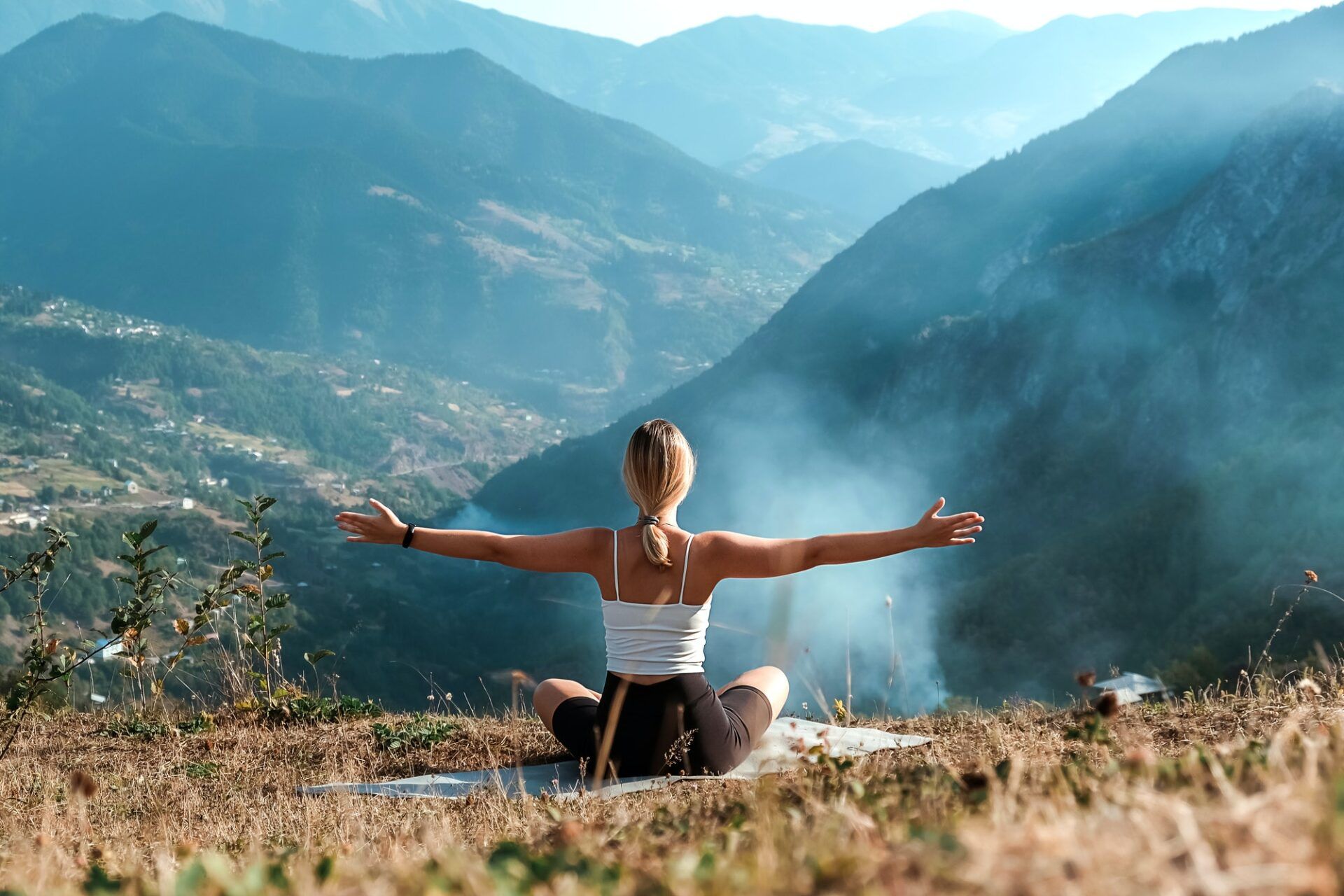 yoga in the mountains. Girl generation z practices in the mountains. Wellness, mental health, medita
